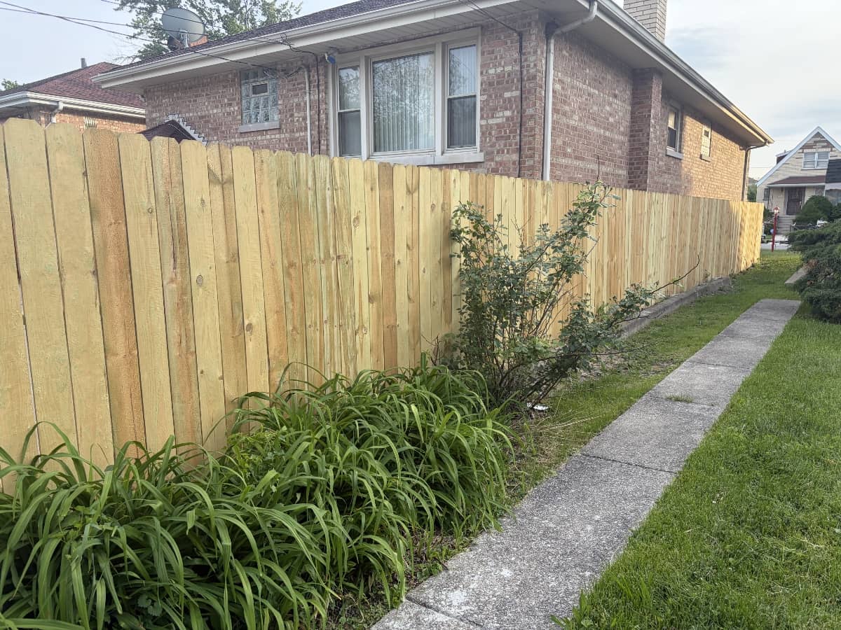 landscaping work with newly installed fence